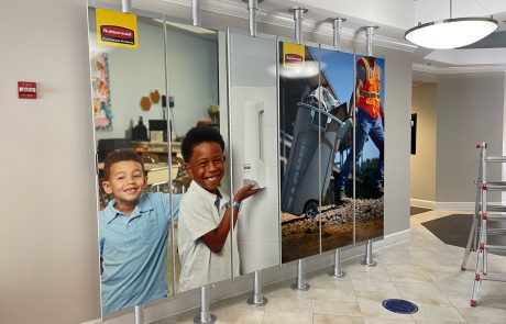 Indoor Custom Acrylic Sign with two elementary aged children and a construction worker taking out the trash
