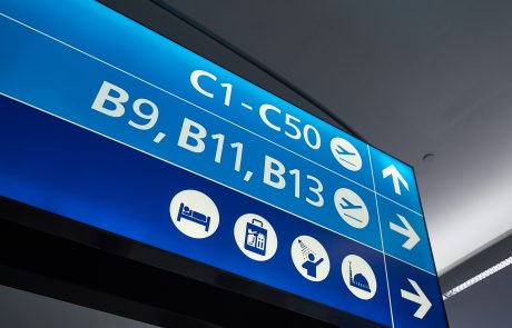 Directional Signage for an airport. Two shades of blue with white letters. C1-C50, B9, B11, B13
