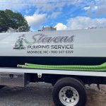 Vehicle decal sign on a truck. Stevens Plumbing Service Monroe, NC 980-347-5359
