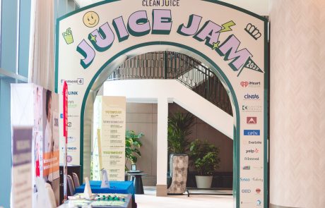 Indoor event sign in off-white background and lite purple letters. Clean Juice, Juice Jam.