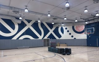 Innovative indoor wall mural for a basketball gym in dark blue and white.