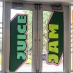 Entry Way Glass Doors with window decals that read, "Juice Jam".