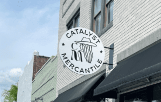 blade sign, custom outdoor round hanging storefront sign for Catalyst Mercantile by Element 4 Signs & Graphics